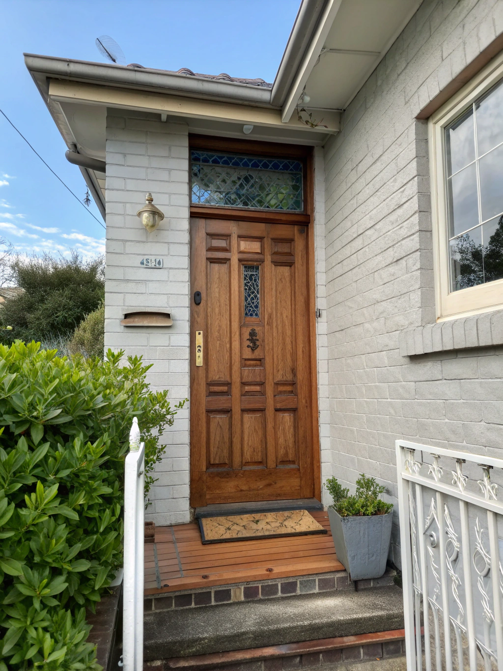 Freshly painted navy blue front entrance door with polished brass hardware