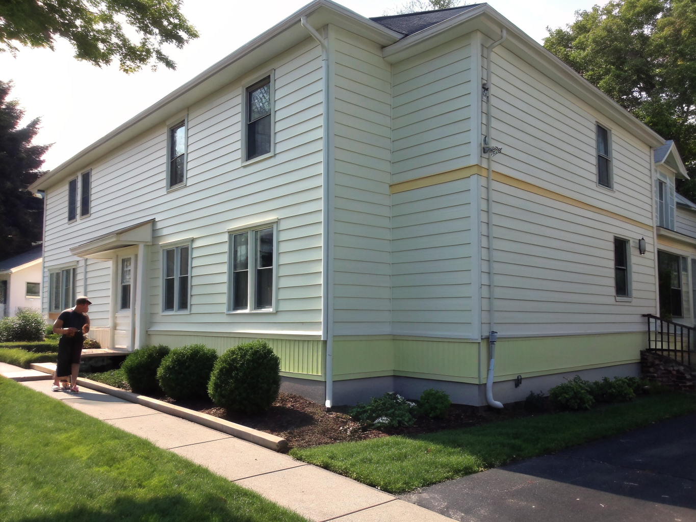Modern facade with freshly painted navy blue vinyl siding